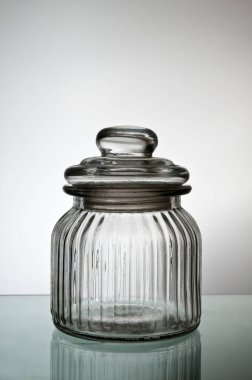 Closed empty glass jar, transluscent.