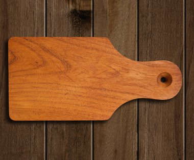 Wooden cutting board  with clipping path on wooden background