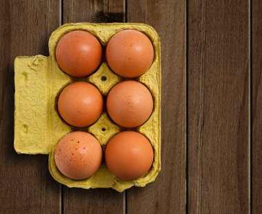 Egg box on wooden table.