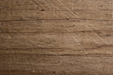 Bunch of potatoes on a net bag, wooden table.