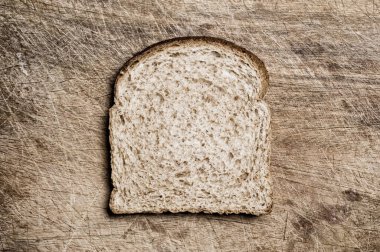 A slice of wholemeal bread on a table.