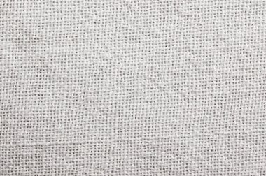 Bunch of potatoes on a net bag, wooden table.