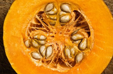 Slice of pumpkin showing seeds, close up shot.