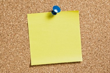 Yellow remainder note on cork background, with blue pin.
