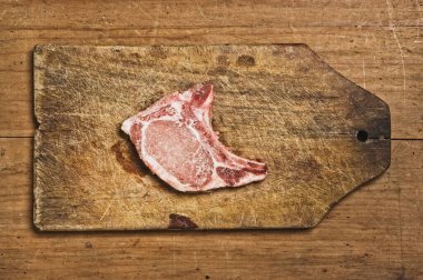 Raw Pork Chop isolated on cutting table. Studio shot.