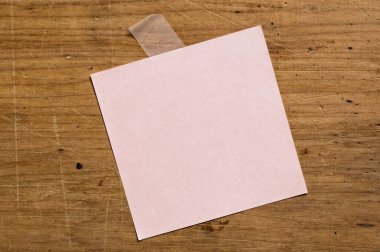 note paper attached with tape on board.