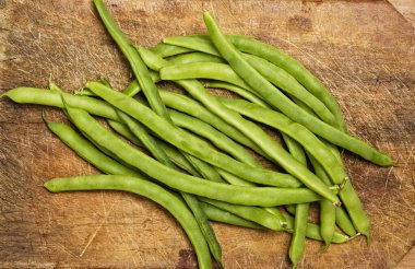 Green beans on wooden table, studio shot. 