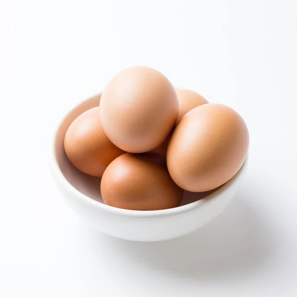 Eggs in white bowl on the white background — Stock Photo, Image