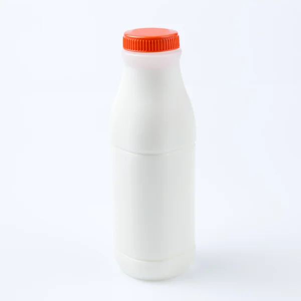 Garrafa de leite no fundo branco — Fotografia de Stock