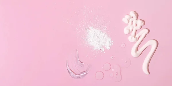 Smears of cream, gel and drops of oil or tincture and pipette on a pink background. Skin care spa concept