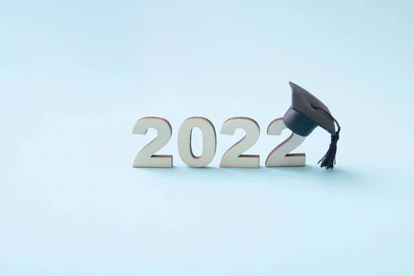 Graduation 2022 Wearing Graduate Hat Wooden Number 2022 Blue Background — 图库照片