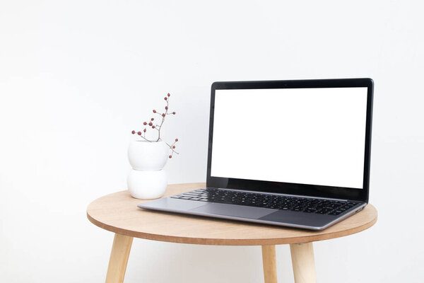 Blank modern laptop screen mockup in minimalistic interior design for displaying your website or advertising internet services.