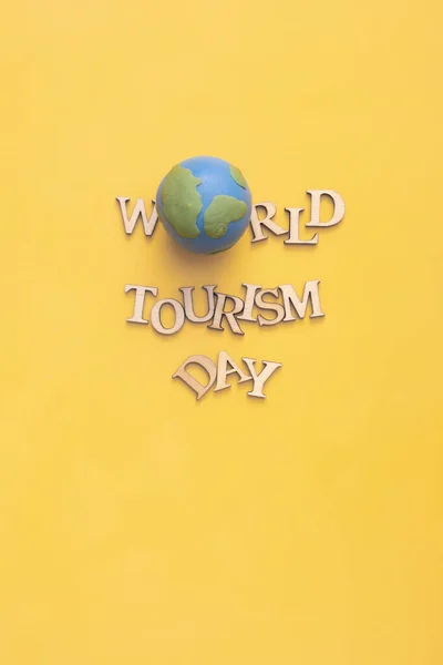 World Tourism Day Text Wooden Letters Globe Yellow Background Top — 스톡 사진