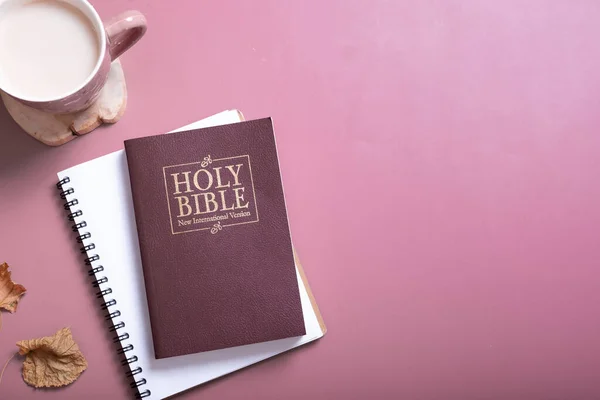 Holy Bible, autumn leaves and Cup of Coffee top view. Holy Bible study concept.