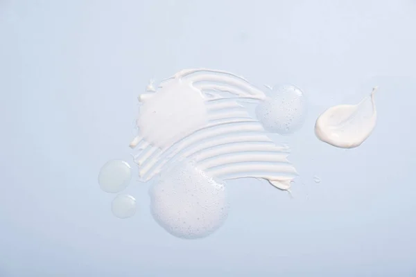 Various Cosmetic Smears Blue Background Top View Lather Soap Foam — 图库照片