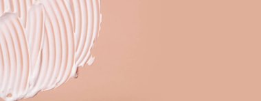Close-up cream moisturiser smear smudge wavy texture on colored background with copy space horizontal format. Skin care beauty product.