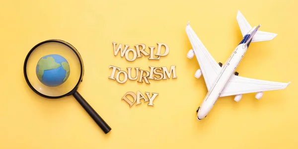 World Tourism Day Text Wooden Letters Yellow Background Globe Magnifying — 스톡 사진