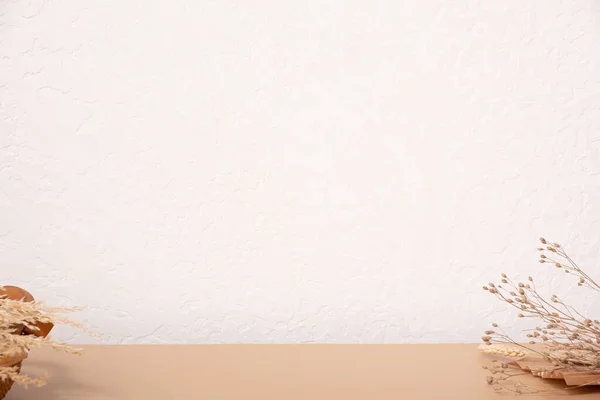 Beige dried grass and wooden basket, empty place on the table.