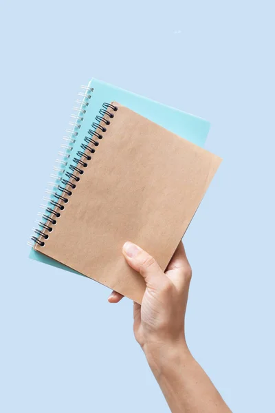 Female Hand Holding Notebook Mock Concept Blue Background Isolated Close — Zdjęcie stockowe