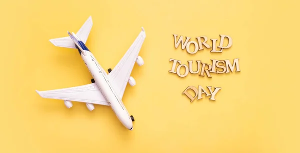 World Tourism Day Text Wooden Letters Yellow Background Airplane Top — 스톡 사진