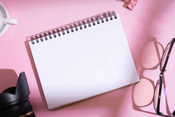 Blank Notebook Slr Camera Glasses Desktop Top View Pink Background — Stock fotografie