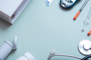 Glucometer and syringes with tablet on color background top view. Means for controlling blood sugar flat lay.