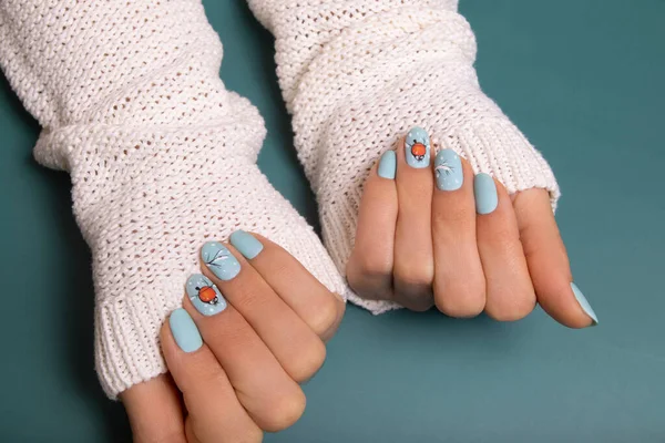 Winter manicure gel polish with stickers under a matte top.