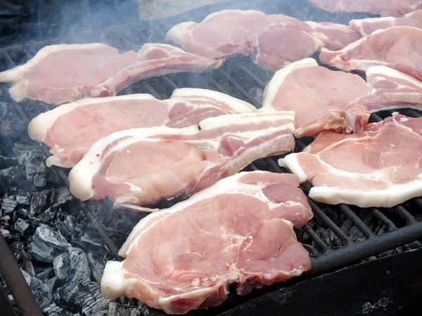 Slices of pork on the grill — Stock Photo, Image
