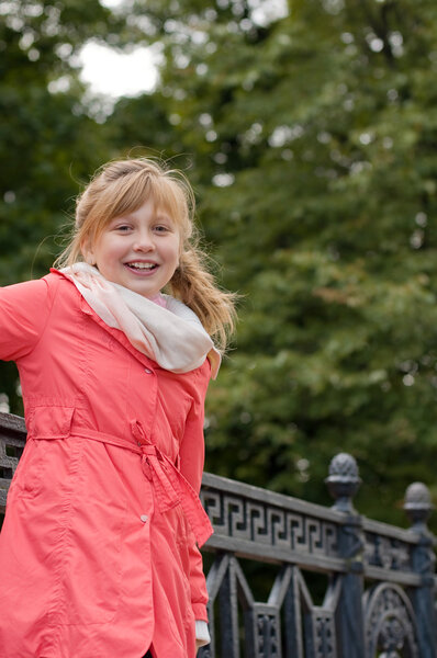 Cheerful teen girl walking in the autumn park
