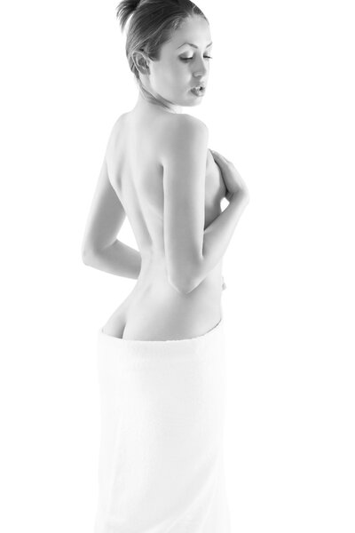 Young nude woman with towel, isolated on white