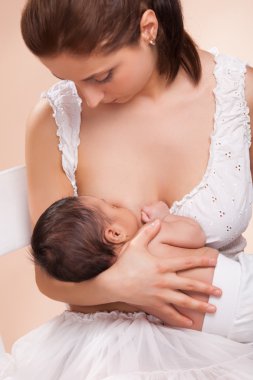 Mother breast feeding her child clipart