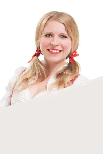 Bavarian woman in dirndl, holding blank signboard. — Stock Photo, Image