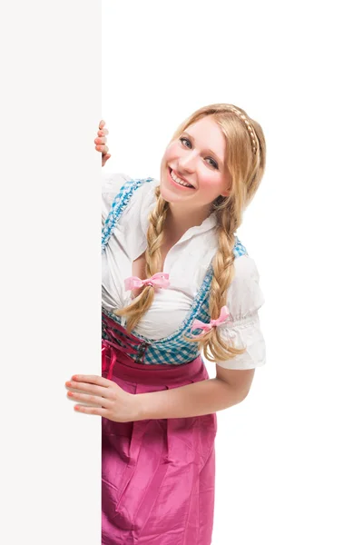 Bavarian woman in dirndl, holding blank signboard. — Stock Photo, Image