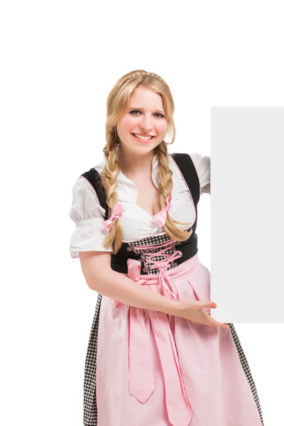 Bavarian woman in dirndl, holding blank signboard. — Stock Photo, Image