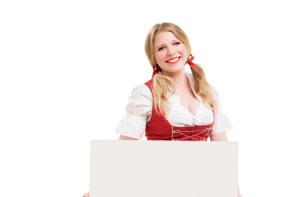 Bavarian woman in dirndl, holding blank signboard. — Stock Photo, Image