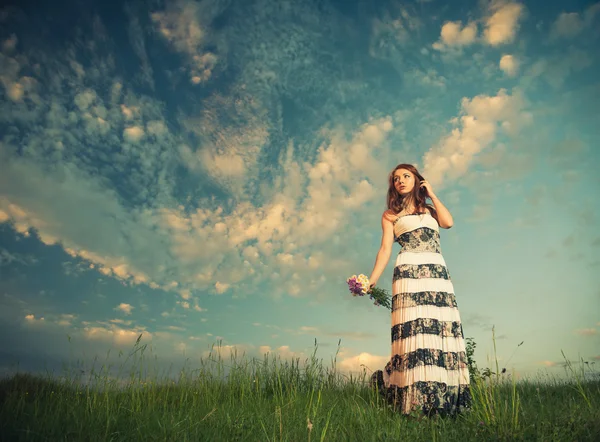 Ung kvinna och solnedgång himlen — Stockfoto