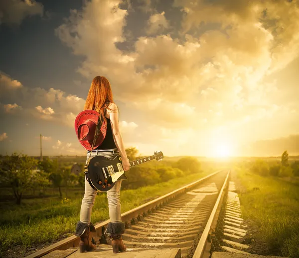 Woman with guitar at railway — Stock Photo, Image