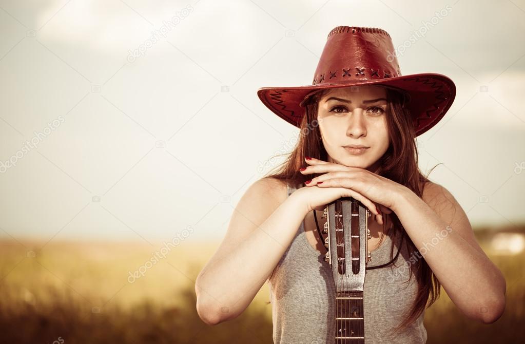 Woman with guitar outdoor portrait