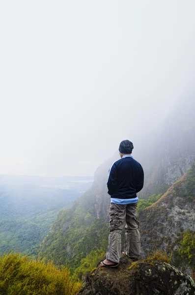 Young man in foggy mountain Stock Photo