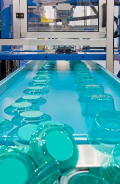 Mass production of plastic containers clipart