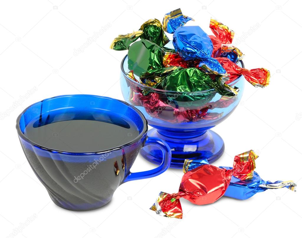 Chocolates and cup of tea on a white background