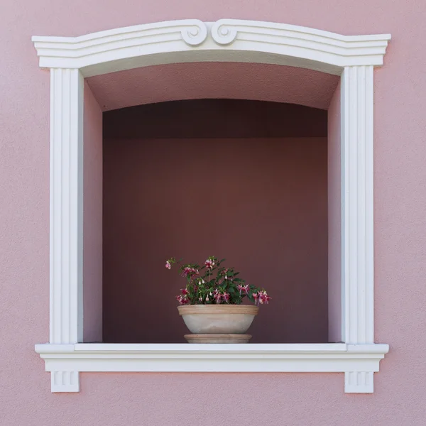 Flowers on arch window — Stock Photo, Image