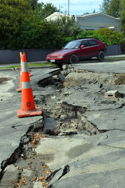Christchurch földrengés - autó beleesik egy repedés a retreat road — Stock Fotó
