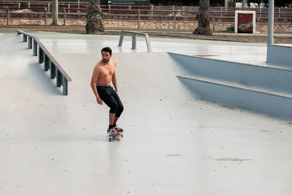 도시의 길거리 스케이트장에서 스케이트보드타는 남자가 반바지를 가슴이 벗겨진 스포츠 방식의 — 스톡 사진