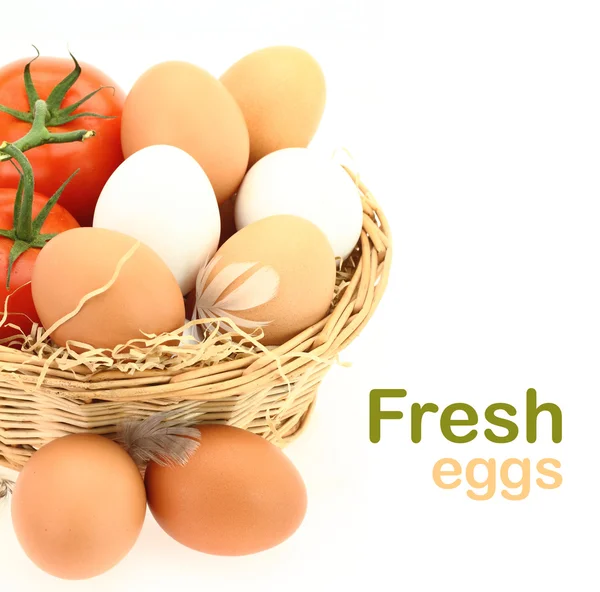 Fresh eggs and tomatoes in the basket — Stock Photo, Image