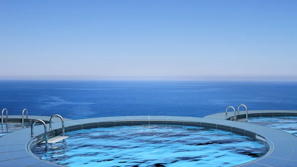 Luxury swimming pool in front of the sea — Stock Photo, Image