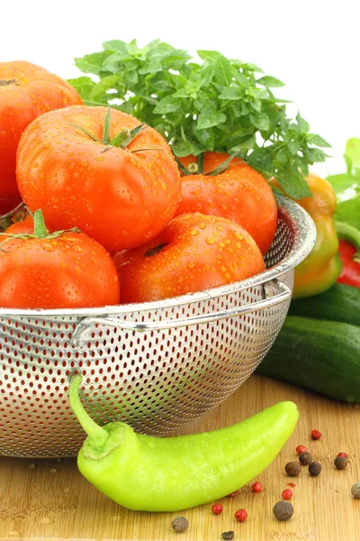 Fresh tomatoes in metal colander — Stock Photo, Image