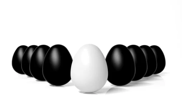 White egg in front of black eggs — Stock Photo, Image