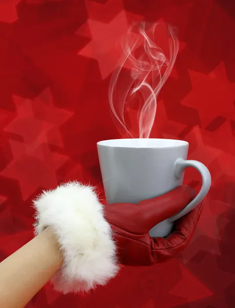 Woman's hand with red glove holding a cup of coffee — Stock Photo, Image