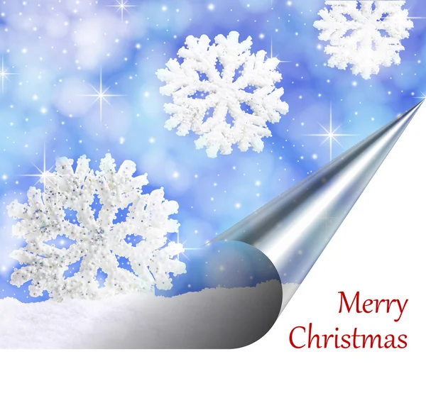 Christmas card. Snowflakes falling from the sky on a page curl — Stock Photo, Image